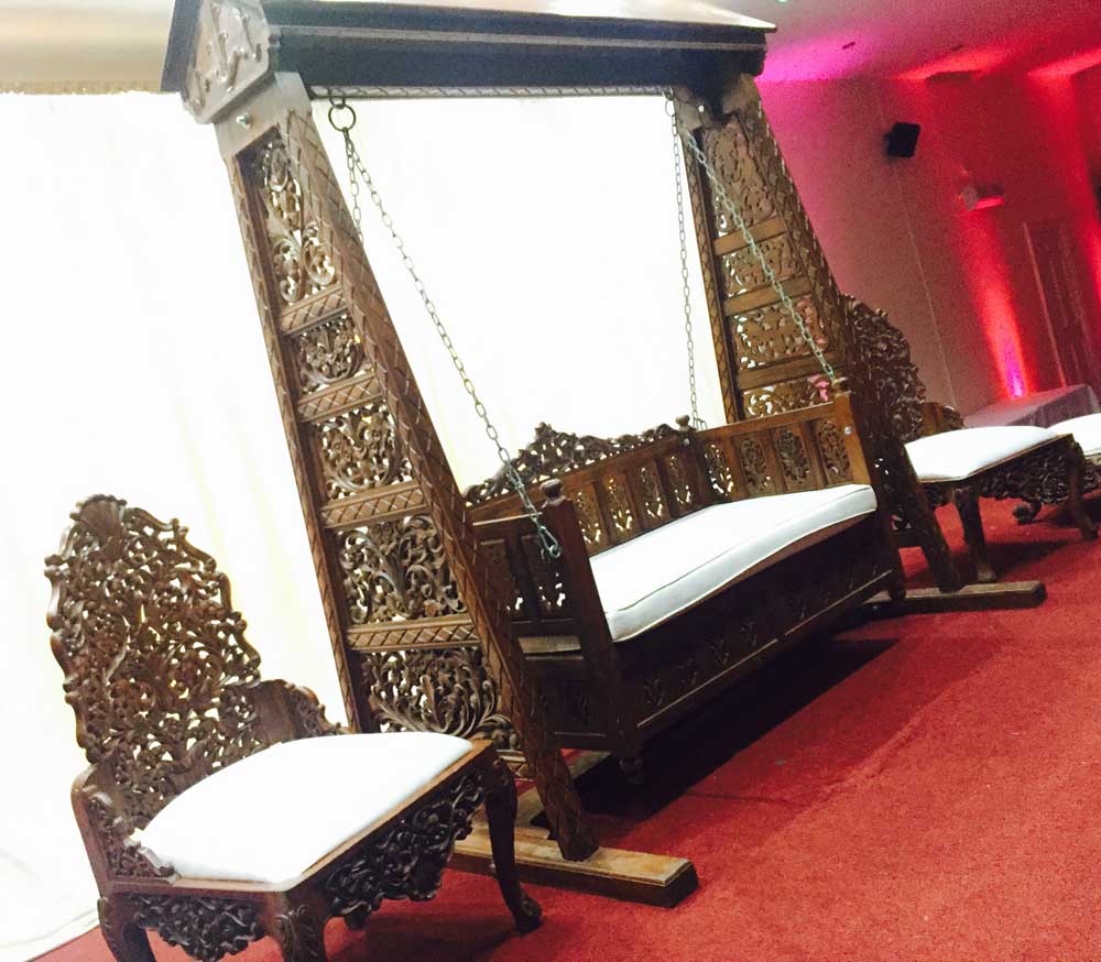 Vibrant Mehndi stage backdrop with colorful drapes
